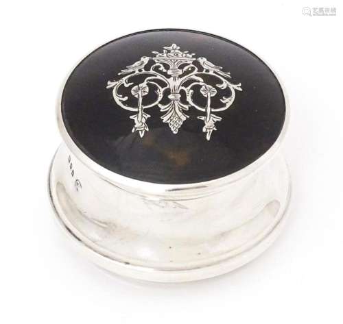 A silver ring box with hinged lid having domed tortoiseshell...