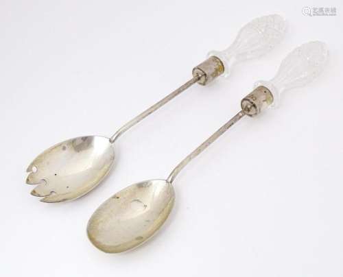 A Victorian pair of silver salad servers with cut glass hand...