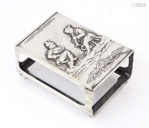 A silver matchbox cover / sleeve with embossed decoration, h...