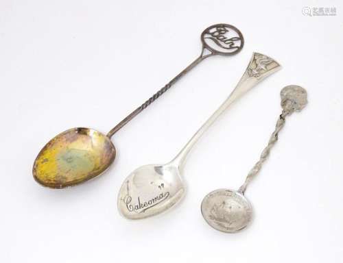 Three assorted spoons to include two silver examples, one ti...