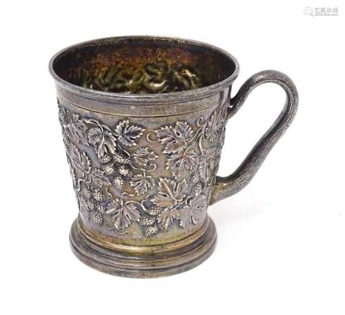 A Victorian silver mug with hop and vine decoration, branch ...