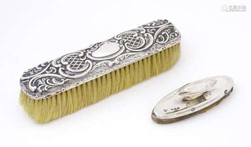 A silver handled brush with embossed decoration, hallmarked ...