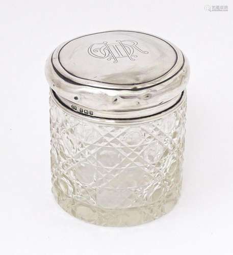 A cut glass dressing table jar with silver lid hallmarked Bi...