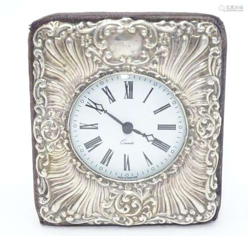 An easel back clock with silver surround. Hallmarked London ...