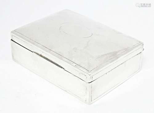 A silver table top cigarette box with hammered decoration, h...