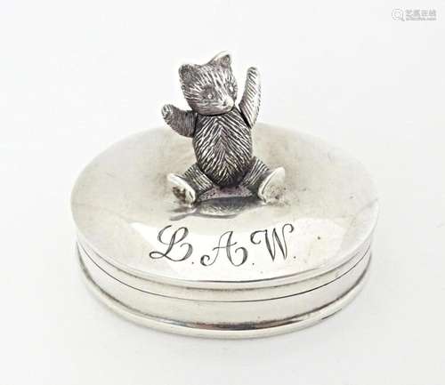 A .925 silver pill box of oval form having articulated bear ...