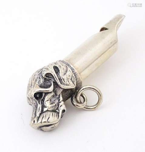 A silver plate whistle with dog head decoration. 3" lon...