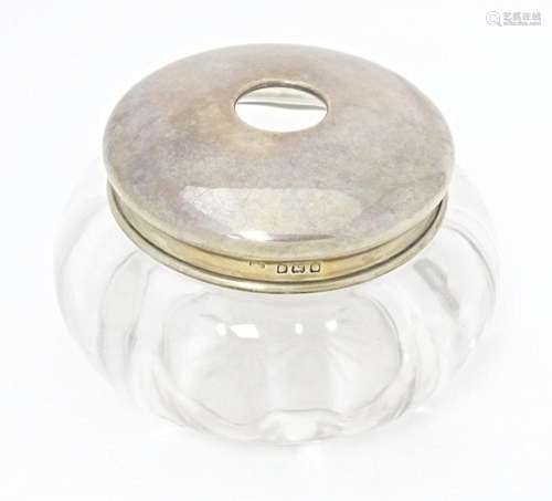 A glass dressing table jar with silver top hallmarked Birmin...