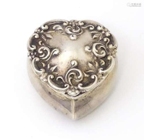 A silver pot of heart form with hinged lid and gilded interi...