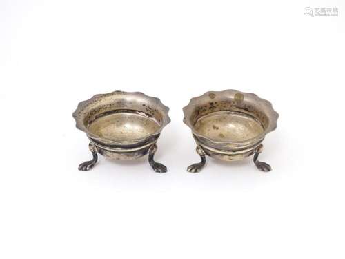 A pair of silver salts raised on three feet. Hallmarked Birm...