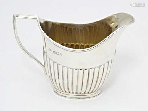 A Victorian silver cream jug with fluted detail, hallmarked ...