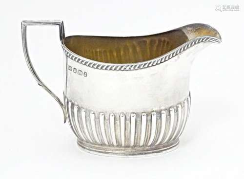 A Victorian silver cream jug hallmarked Sheffield 1896, make...