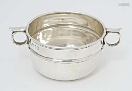 A silver salt formed as a miniature porringer with twin loop...