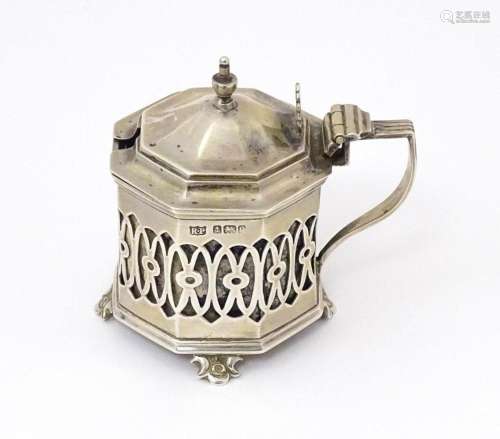 A silver mustard pot with pierced decoration. Hallmarked Bir...