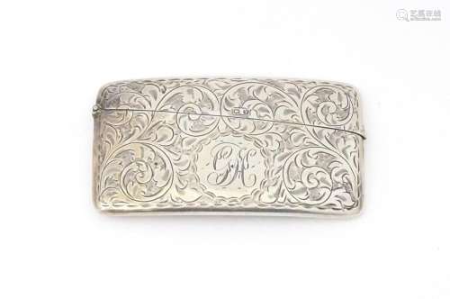 A silver card case with engraved acanthus scroll decoration....