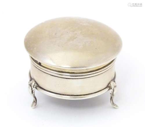 A silver ring box of circular form with hinged lid and raise...