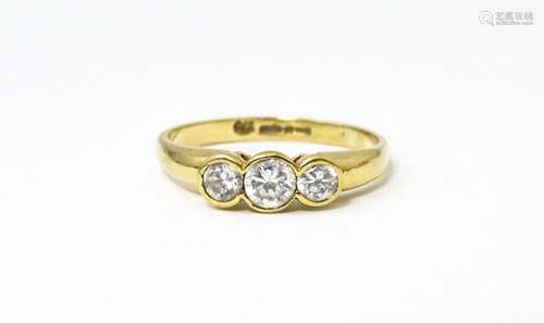 A 9ct gold ring set with a trio cubic zirconia. Ring size ap...