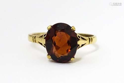 A 9ct gold ring set with central garnet. Ring size approx. M