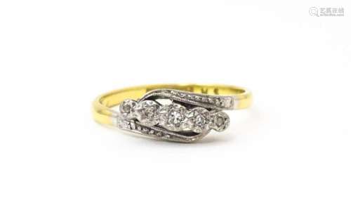 An 18ct gold ring with platinum set diamonds. Ring size appr...