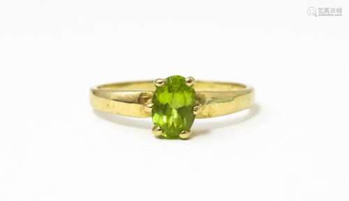 A 9ct gold ring set with central peridot. Ring size approx. ...