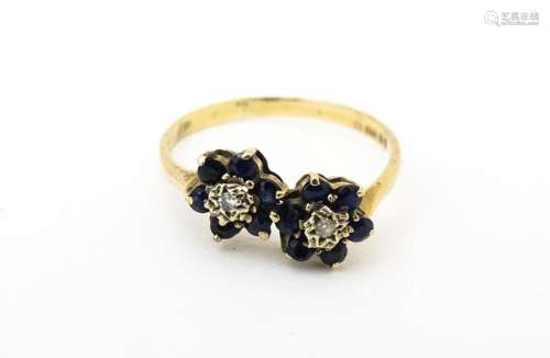 A 9ct gold ring set with diamonds and spinel. Ring size appr...