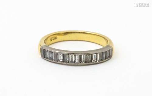 An 18ct gold half eternity ring set with 15 baguette cut dia...