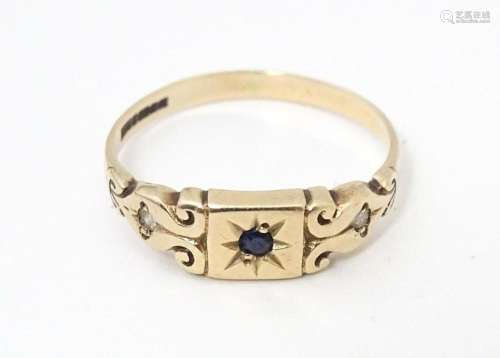 A 9ct gold ring set with central sapphire P 1/2