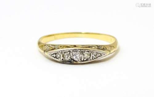 An 18ct gold ring set with 5 graduated diamonds. Ring size a...