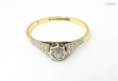 An 18ct gold ring with platinum set diamond. Ring size appro...