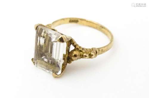 A 9ct gold ring set white stone. Hallmarked London 1965 make...