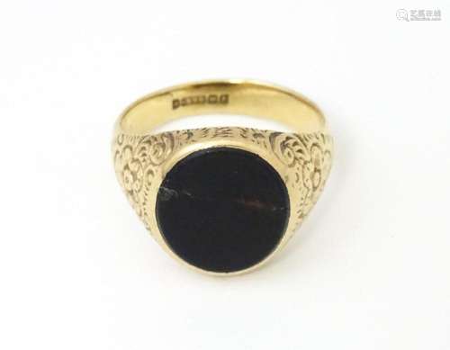 A 9ct gold signet ring set with onyx. Ring size approx. M 1/...