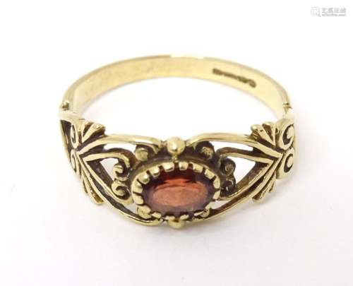 A 9ct gold ring set with central garnet. Ring size approx M