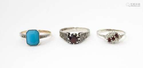 Three various rings to include a silver ring set with garnet...