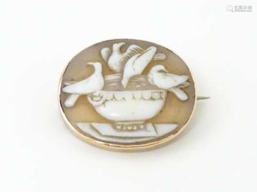 A Victorian cameo brooch with bird decoration, within a yell...