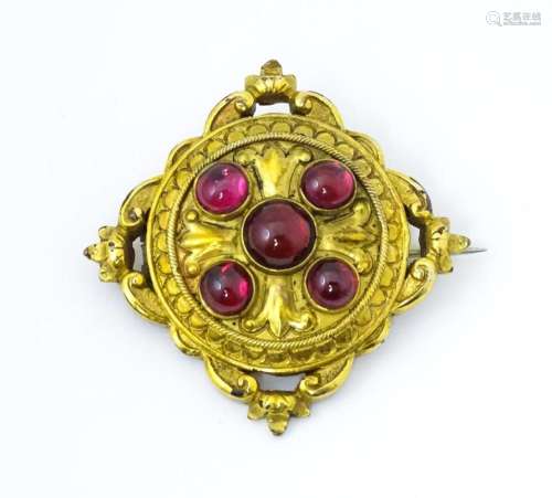 A Victorian yellow metal brooch set with five garnet cabocho...