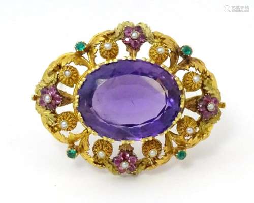 An impressive Victorian brooch set with large central amethy...