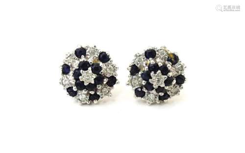A pair of 9ct gold stud earrings set with diamond and spinel...