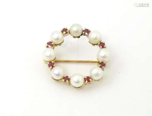 A 9ct gold pendant / brooch of circular set with pearls and ...