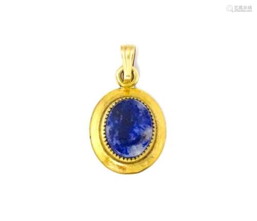A Continental gilt metal pendant with lapiz lazuli set to ce...