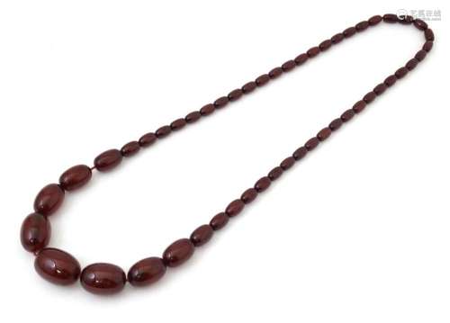 A vintage cherry amber coloured graduated bead necklace. The...