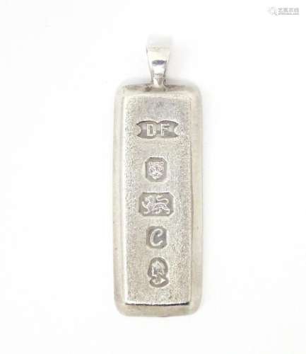 A silver pendant of ingot form hallmarked London 1977 maker ...