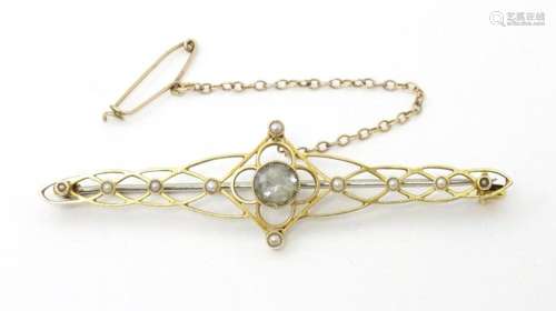 A 15ct gold brooch set with seed pearls and central aquamari...