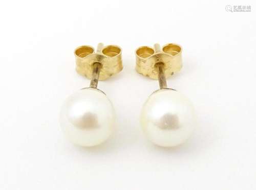 A pair of 9ct gold stud earrings set with pearls. Approx 1/4...