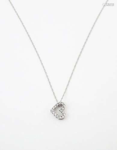 A 14ct white gold pendant of heart form set with diamonds, w...