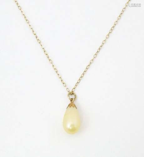 A 9ct gold necklace with pendant drop. The chain 16" lo...