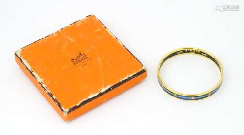 A bangle formed bracelet marked 'Hermes Paris ' and ...