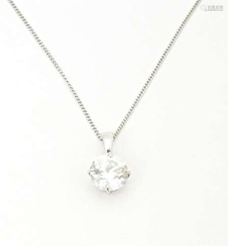 A 9ct white gold chain with pendant set with white stone. Ch...