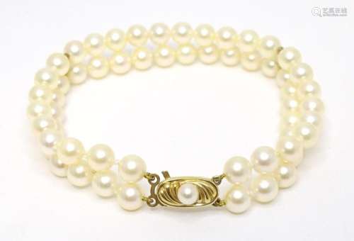 A two strand pearl bracelet with 9ct gold clasp. Approx 7 1/...