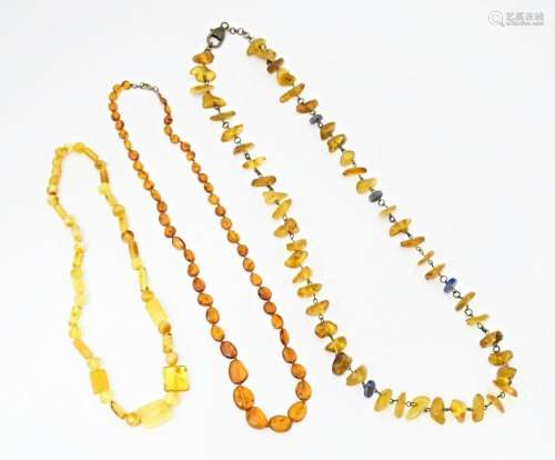 Three various amber coloured bead necklaces. The longest als...