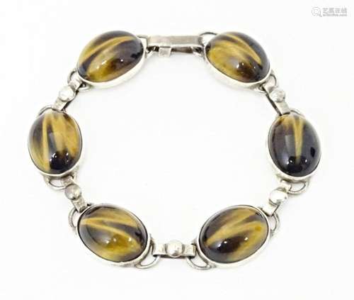 A silver bracelet with 6 tigers eye cabochon. Approx 7 1/2&q...